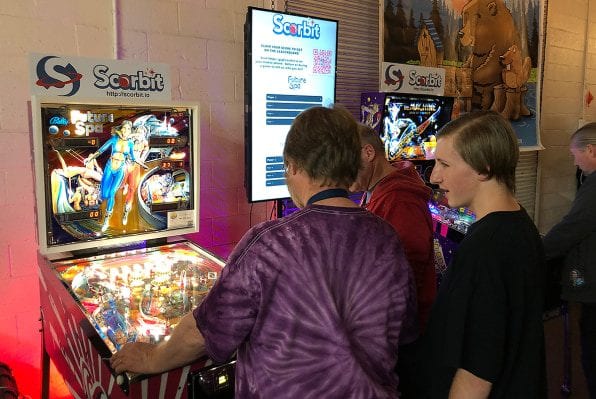 Pinball fans trying out a Scorbit-enabled machine